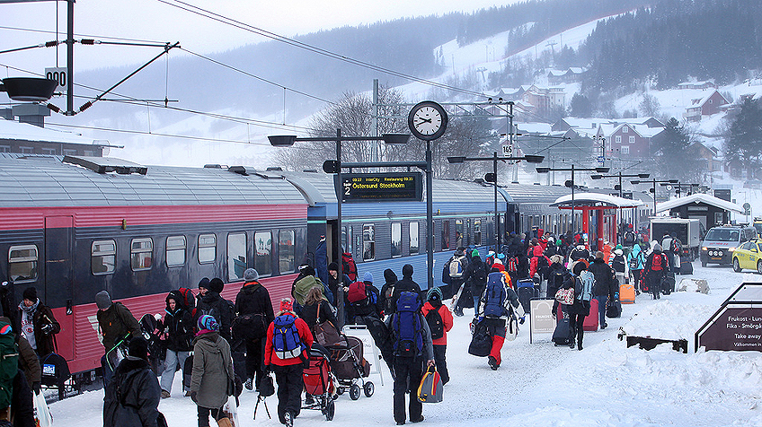 Travellers arriving by train at Åre station in winter